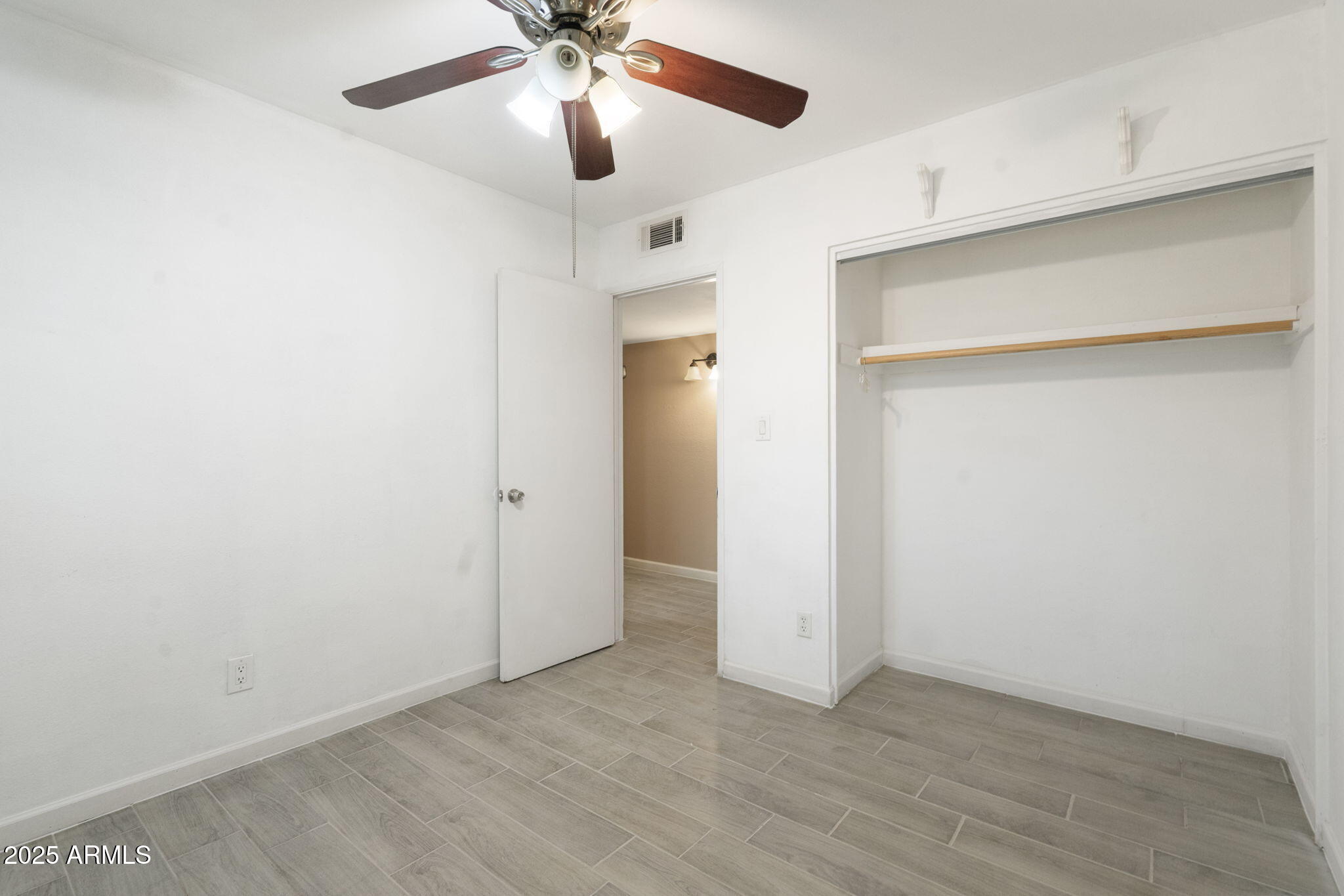 1121 West Halstead Drive Phoenix, AZ 85023 - Photo 16 of 22 an empty room with a ceiling fan and a window