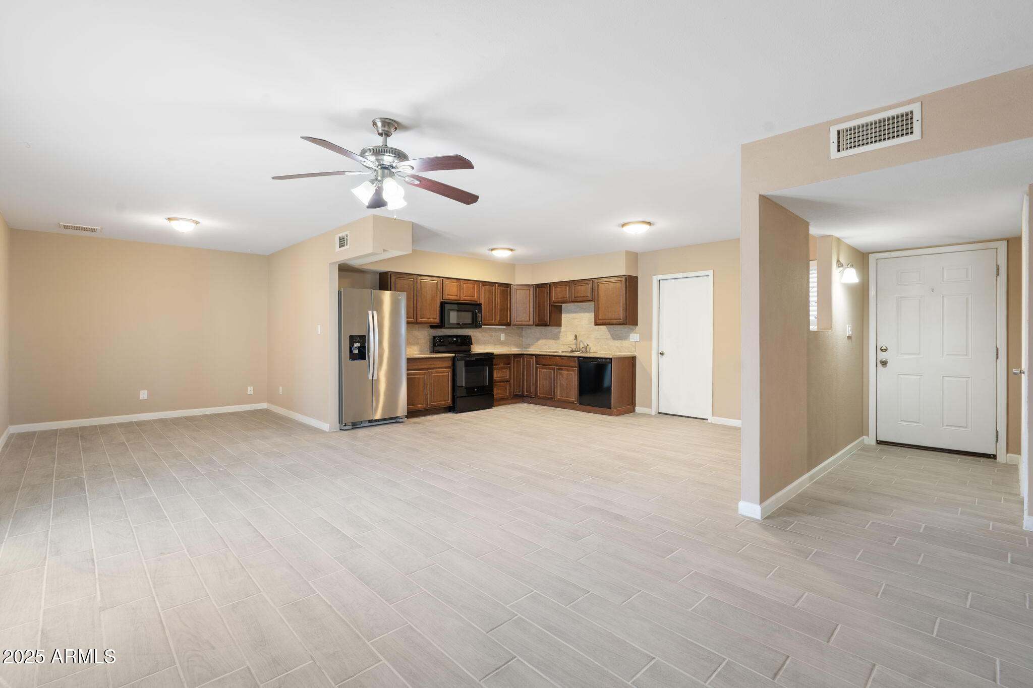 1121 West Halstead Drive Phoenix, AZ 85023 - Photo 3 of 22 a view of a kitchen with a sink and a refrigerator