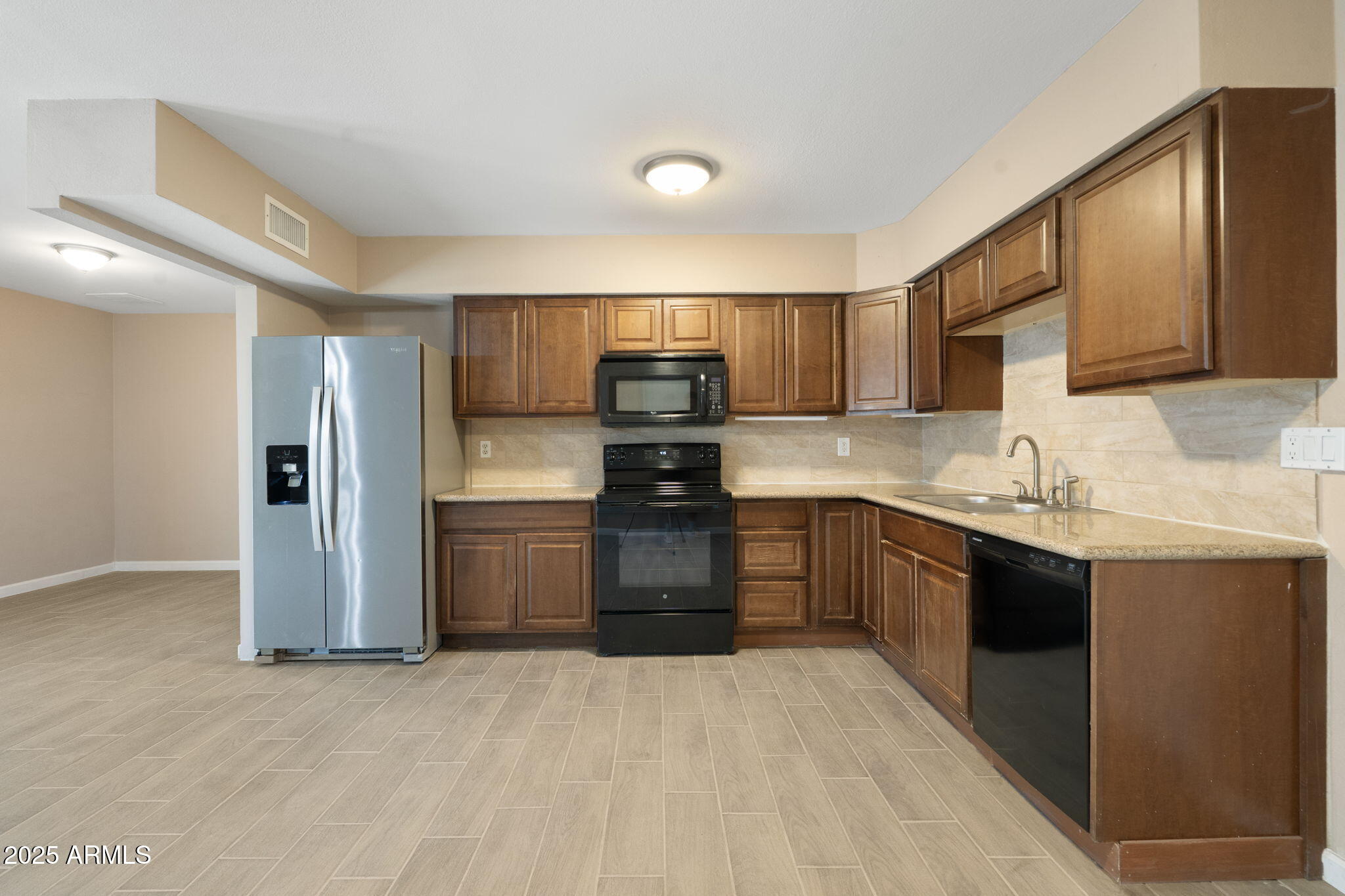 1121 West Halstead Drive Phoenix, AZ 85023 - Photo 6 of 22 a kitchen with a sink cabinets and stainless steel appliances