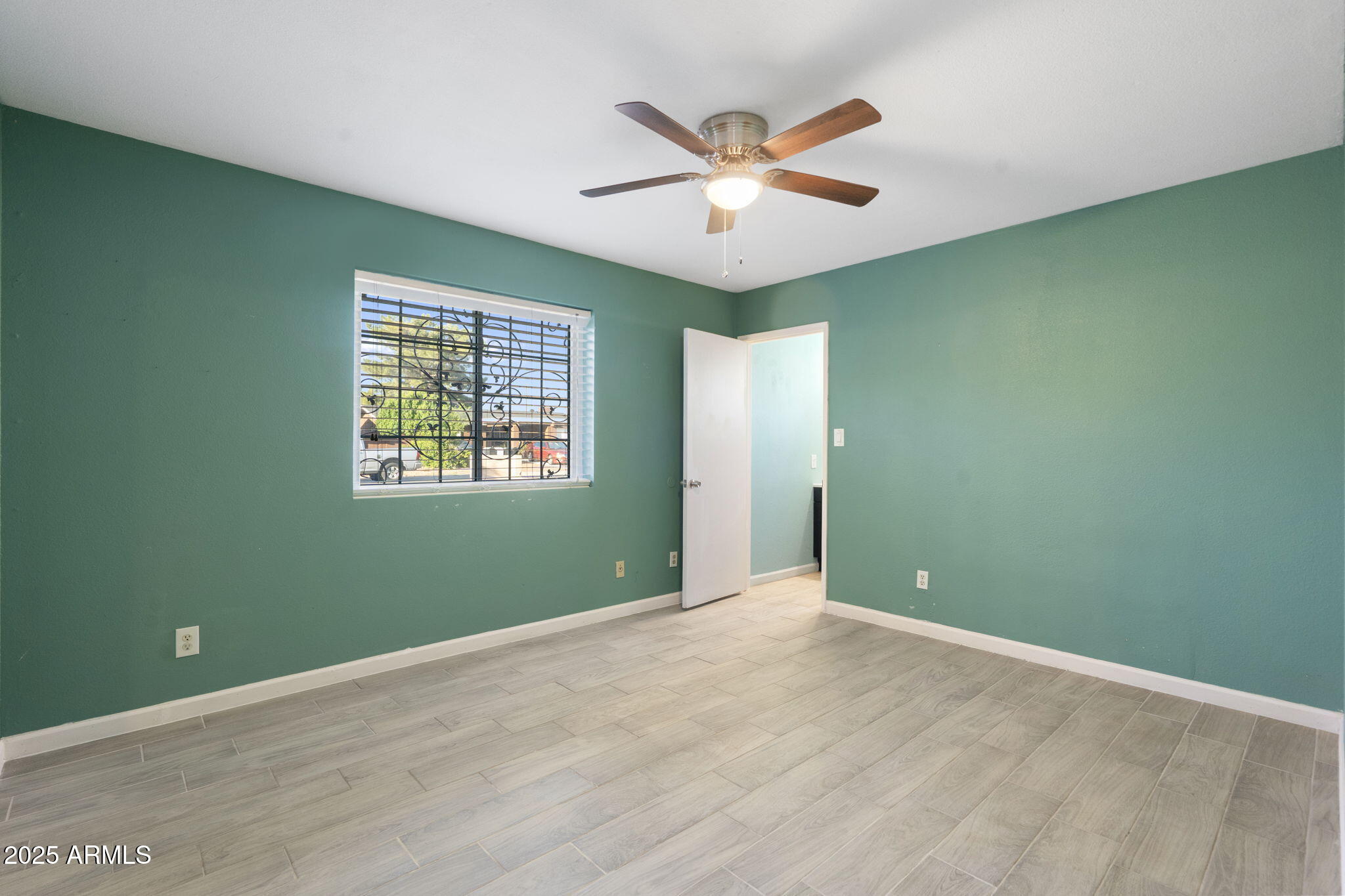 1121 West Halstead Drive Phoenix, AZ 85023 - Photo 10 of 22 an empty room with window and ceiling fan
