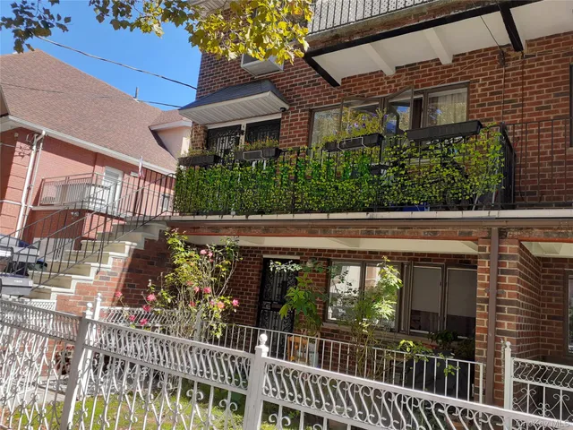 a view of a brick house with a large window