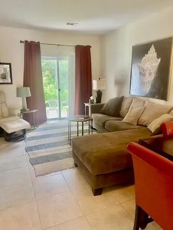 a living room with furniture and a large window