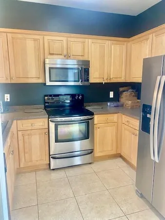 a kitchen with a stove and a refrigerator