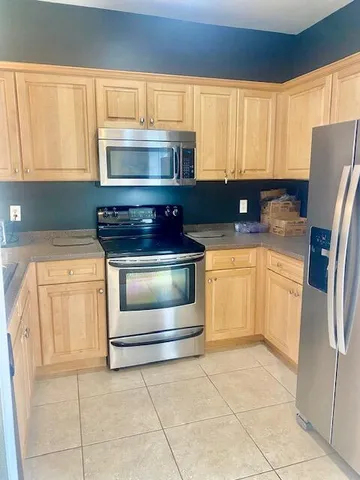 a kitchen with a stove and a refrigerator