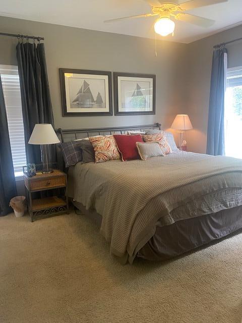 34 Heron's Watch Way, Unit 6104 Santa Rosa Beach, FL 32459 - Photo 6 of 8 a bedroom with a bed and a chandelier