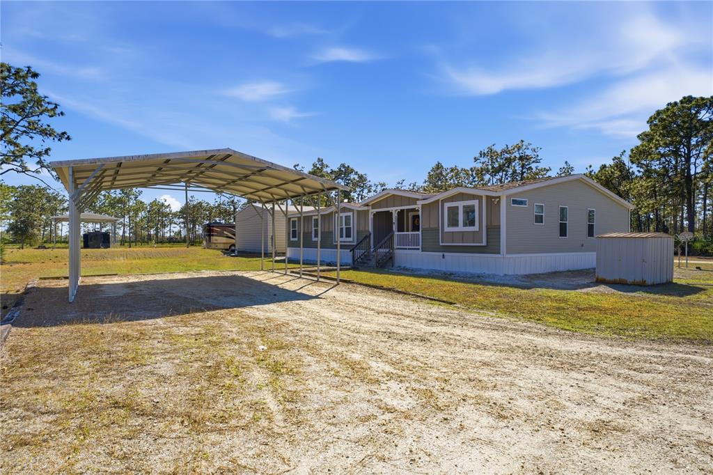6844 Chad Jason Road St. Cloud, FL 34773 - Photo 3 of 59 a view of a house with swimming pool and a yard