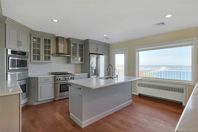 a kitchen with stainless steel appliances granite countertop a stove and a refrigerator