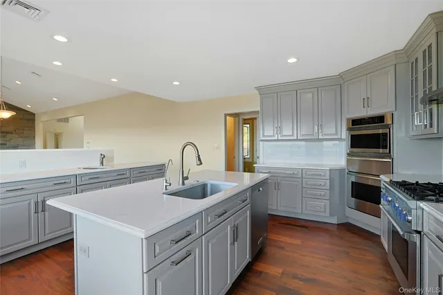 a kitchen that has a sink and a stove in it
