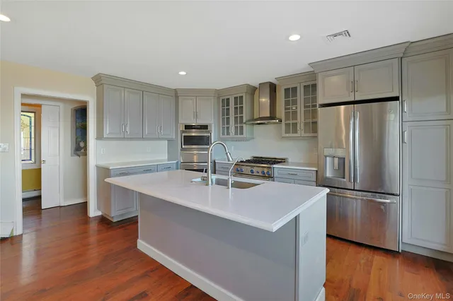 a kitchen with stainless steel appliances a refrigerator sink and microwave