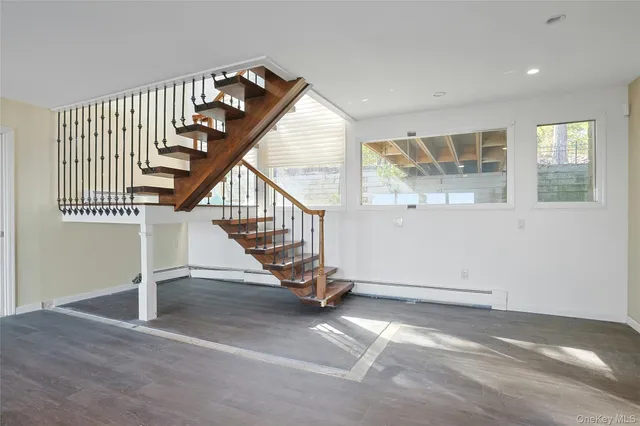 a view of an entryway with wooden floor