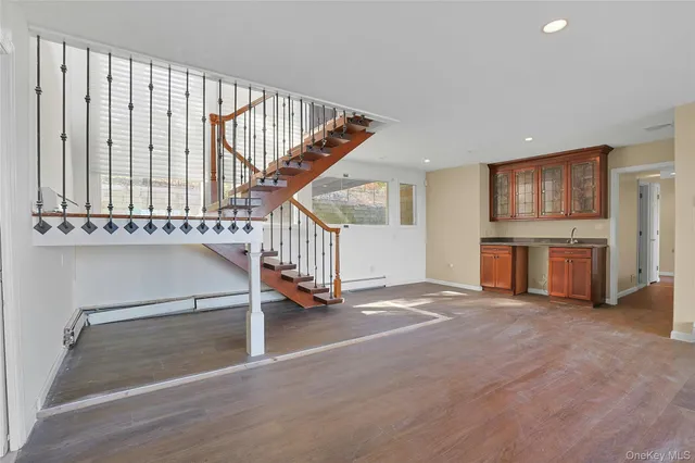 a view of an empty room with a fireplace and a window