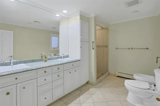 a bathroom with a granite countertop sink a toilet and a shower
