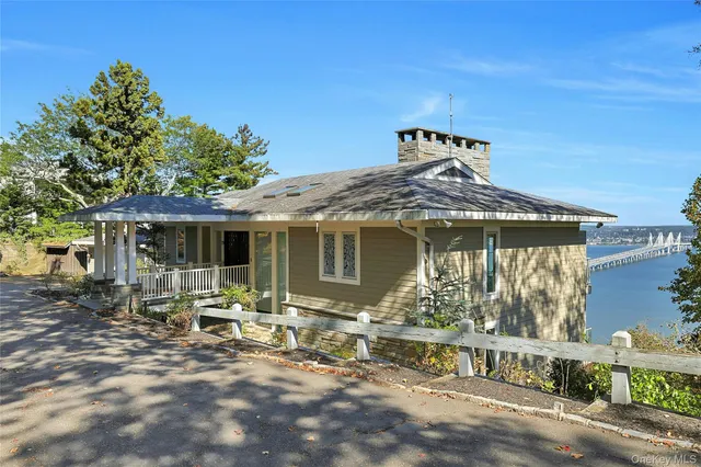 a view of a house with backyard porch and sitting area