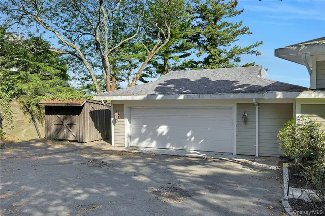 a view of a house with a yard and garage