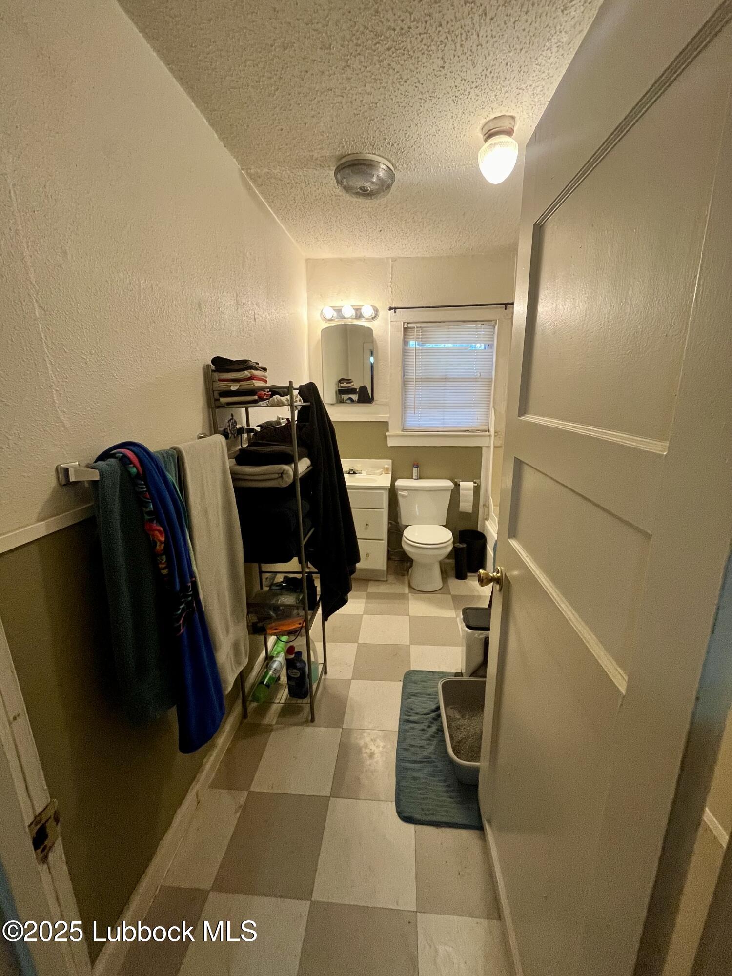 2819 35th Street Lubbock, TX 79413 - Photo 12 of 16 a bathroom with a toilet and a shower