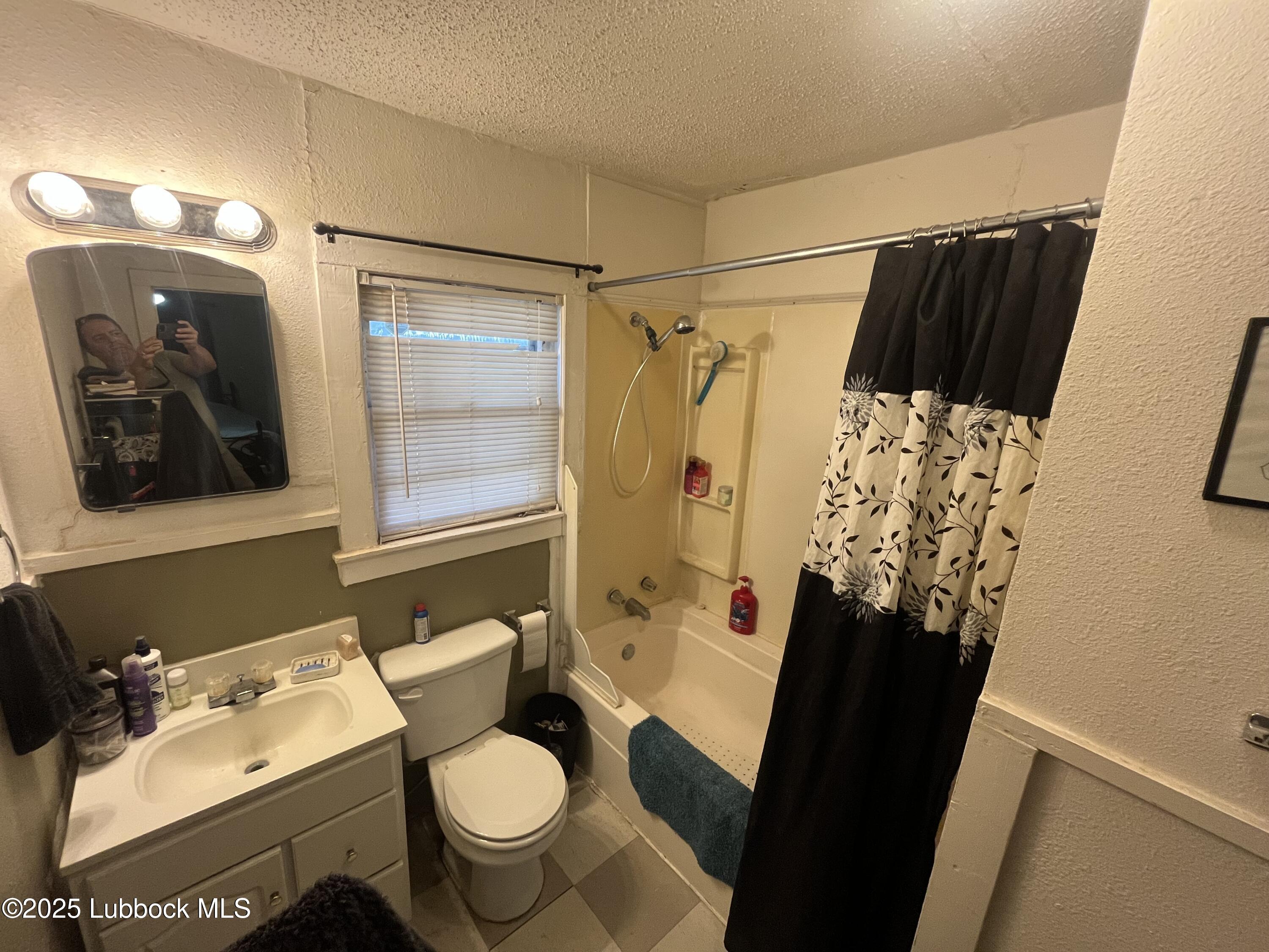 2819 35th Street Lubbock, TX 79413 - Photo 13 of 16 a bathroom with a sink toilet and shower