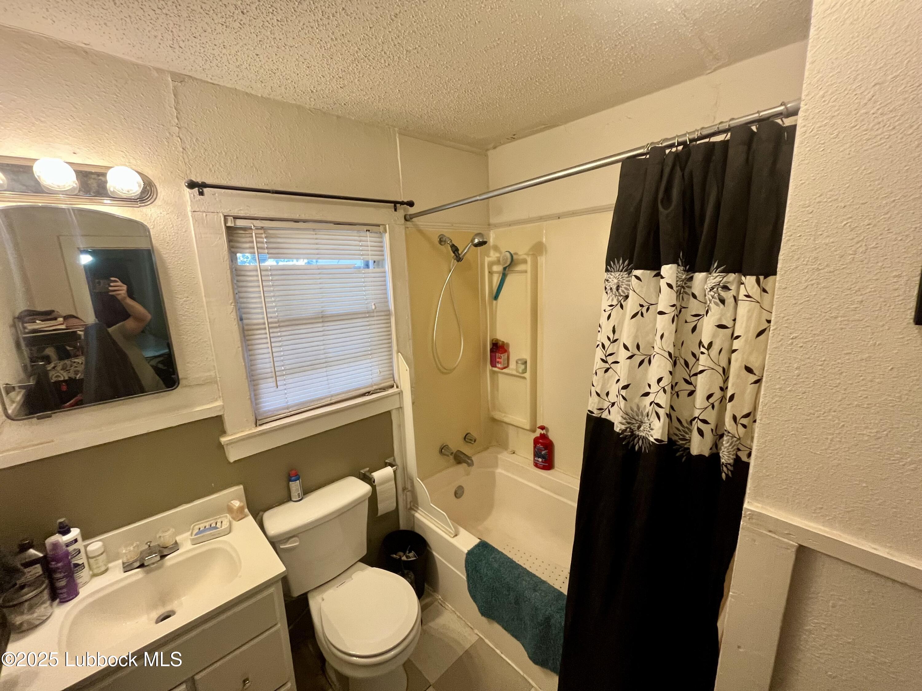 2819 35th Street Lubbock, TX 79413 - Photo 14 of 16 a bathroom with a sink toilet and shower