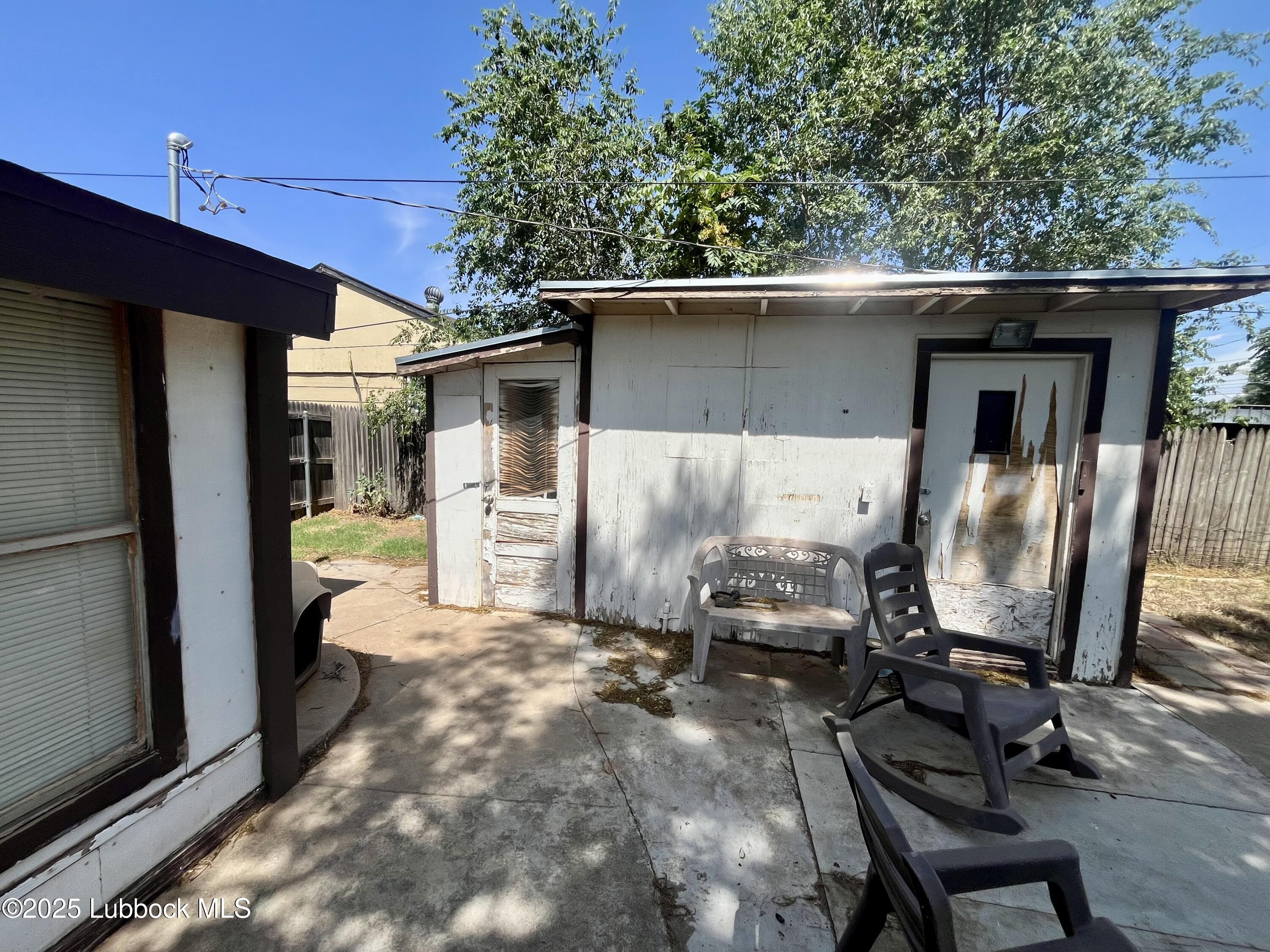 2819 35th Street Lubbock, TX 79413 - Photo 16 of 16 a view of a two chairs in the back yard of the house