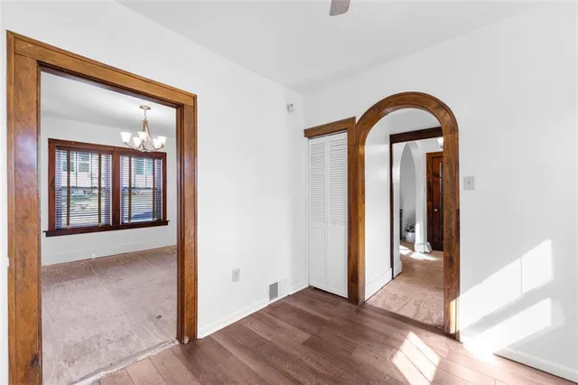 a view of a room with wooden floor and mirror