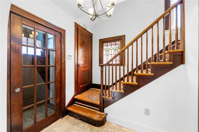 a view of staircase with wooden floor and windows