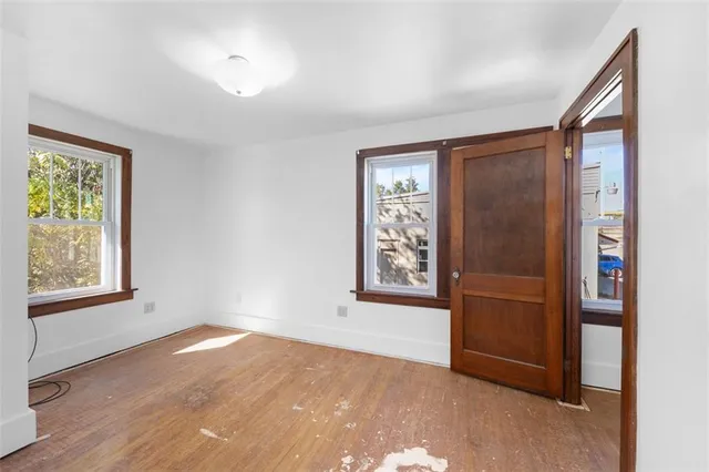 an empty room with windows closet and livingroom