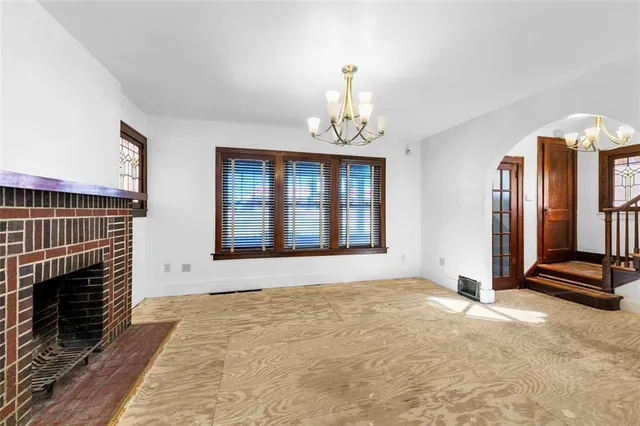 a view of an empty room with exposed radiator