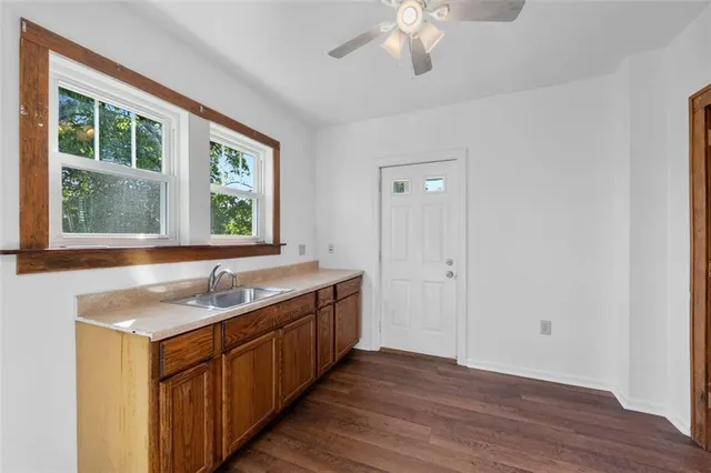 a bathroom with a granite countertop sink and a window