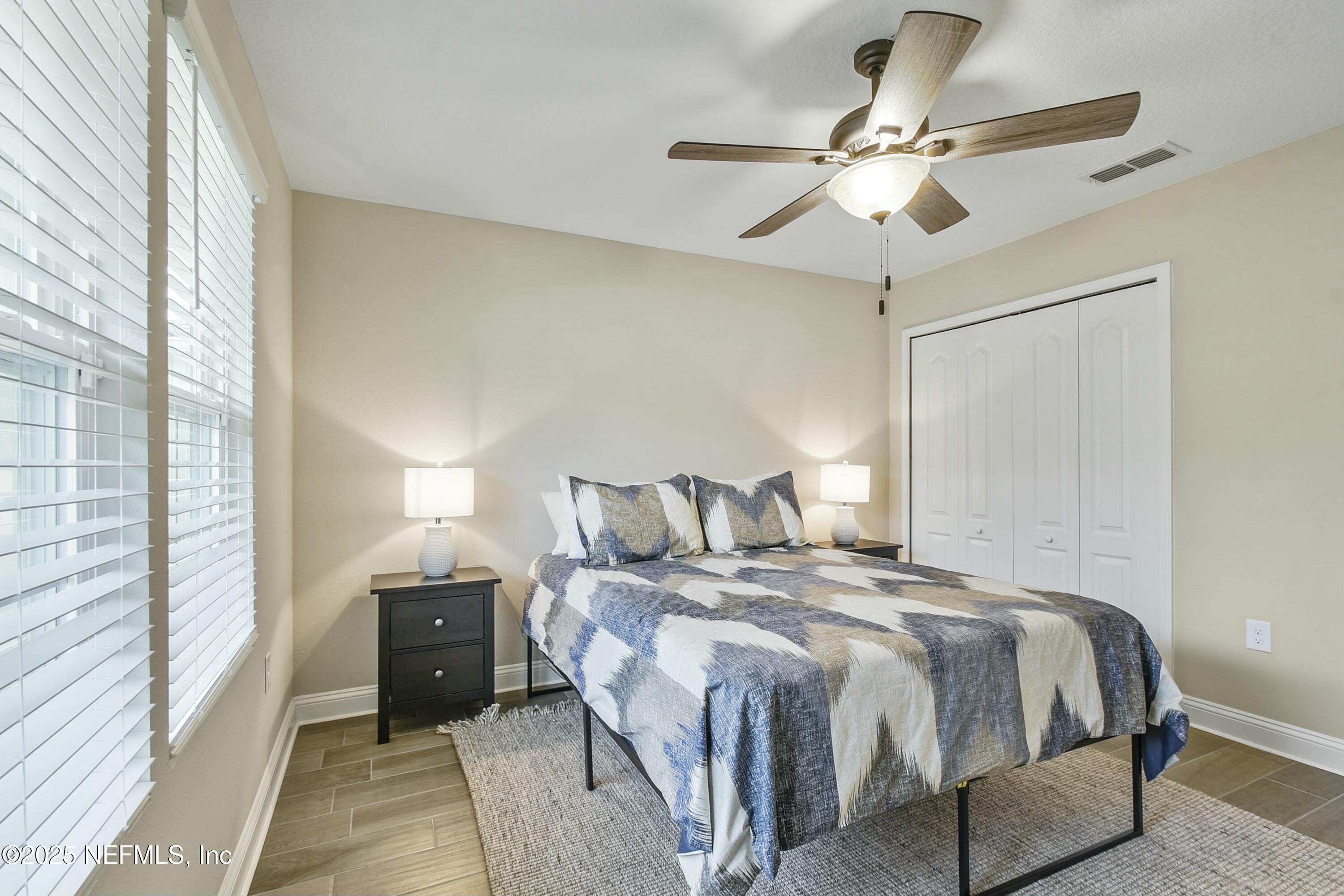 1399 Parkland Trail St. Augustine, FL 32095 - Photo 20 of 39 a bedroom with a bed and a ceiling fan