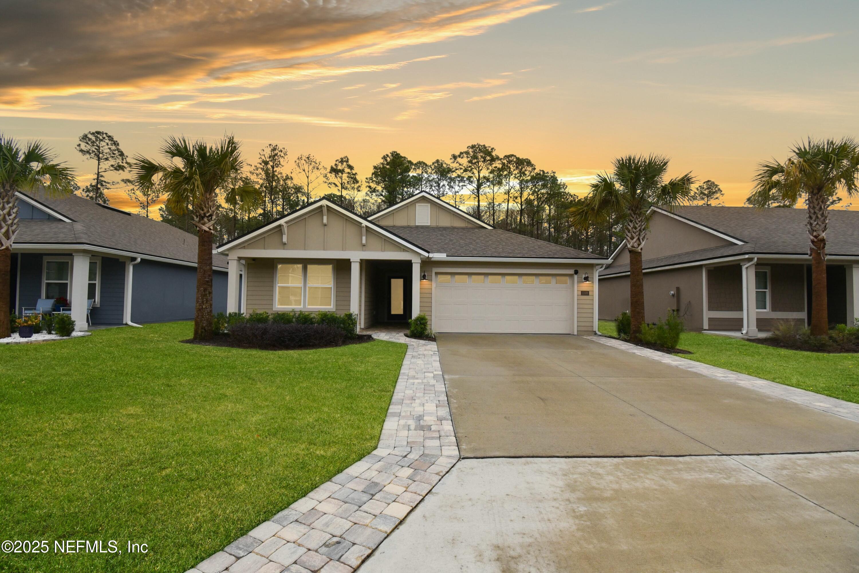 1399 Parkland Trail St. Augustine, FL 32095 - Photo 2 of 39 a view of a yard in front of a house with a large tree