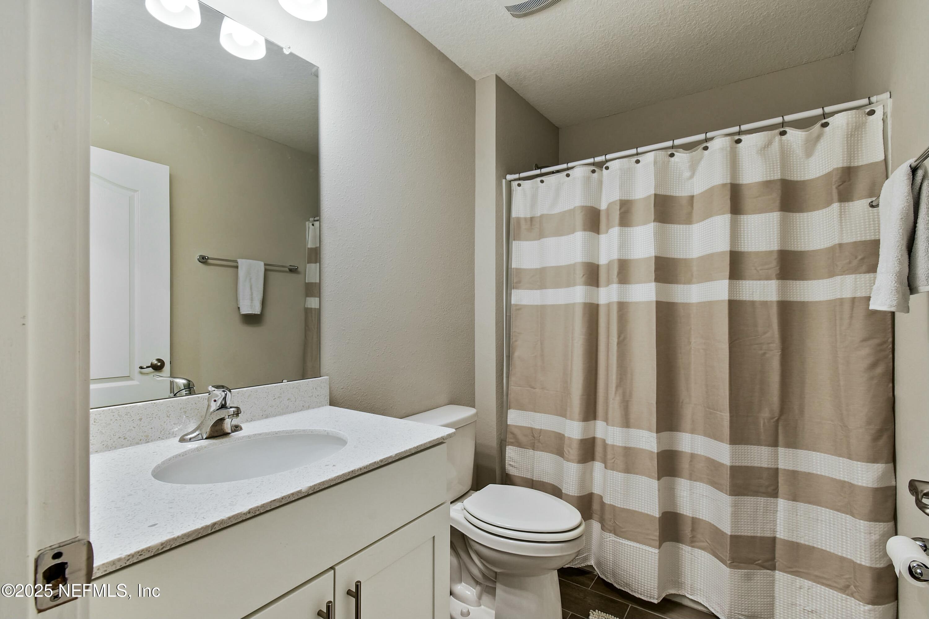 1399 Parkland Trail St. Augustine, FL 32095 - Photo 22 of 39 a bathroom with a sink and a mirror