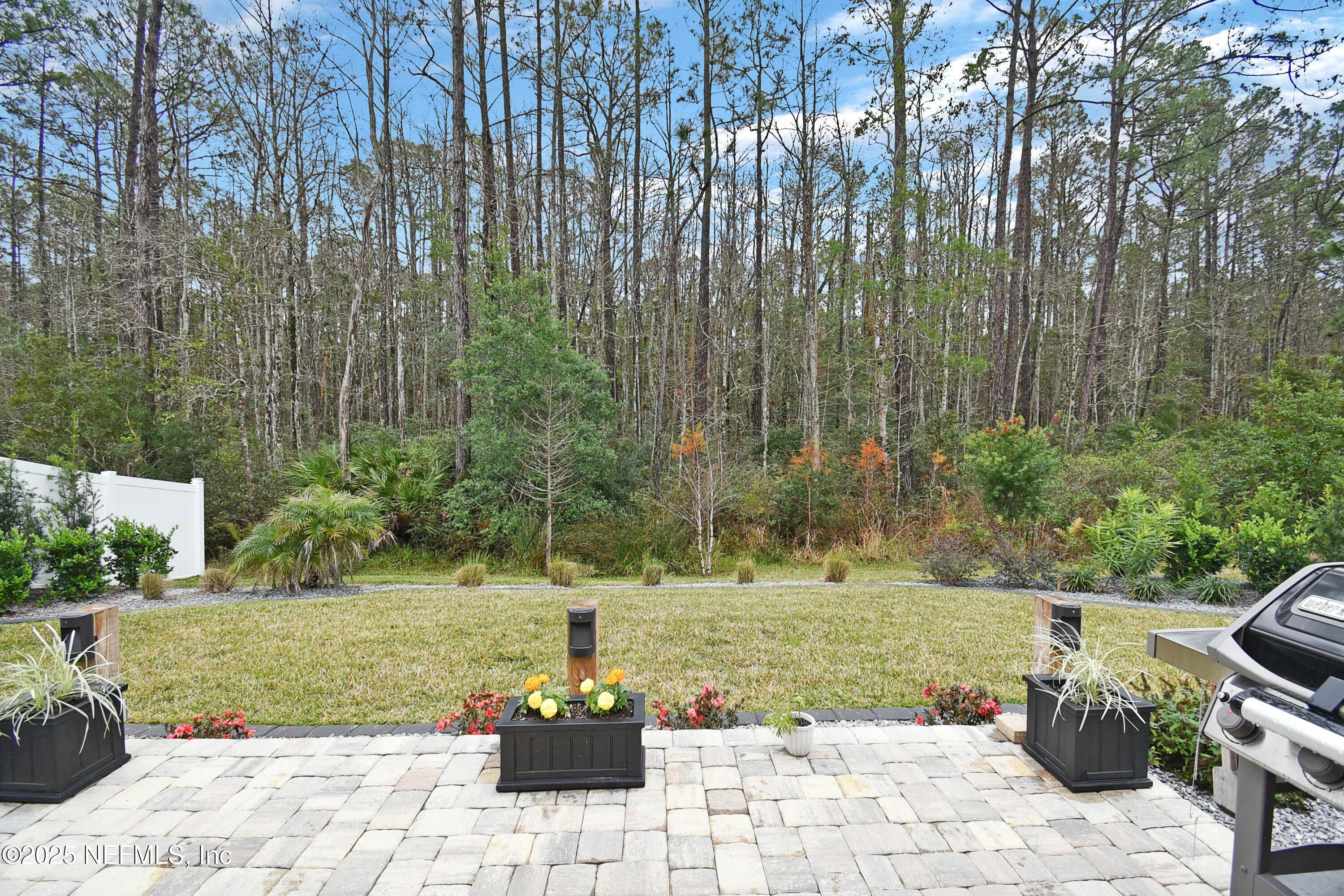 1399 Parkland Trail St. Augustine, FL 32095 - Photo 27 of 39 a view of a garden with a bench