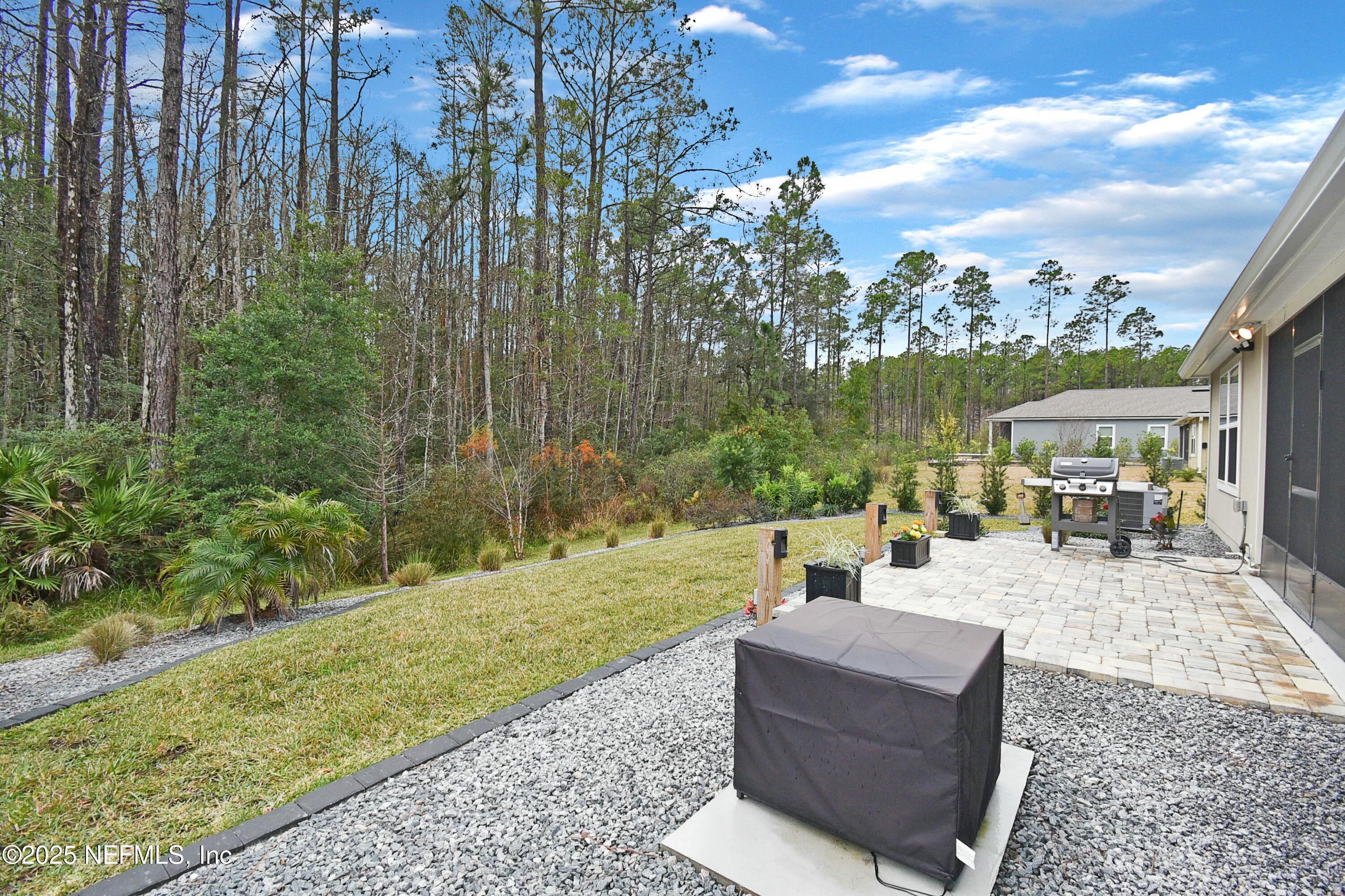 1399 Parkland Trail St. Augustine, FL 32095 - Photo 28 of 39 a view of a patio with couches chairs and a big yard