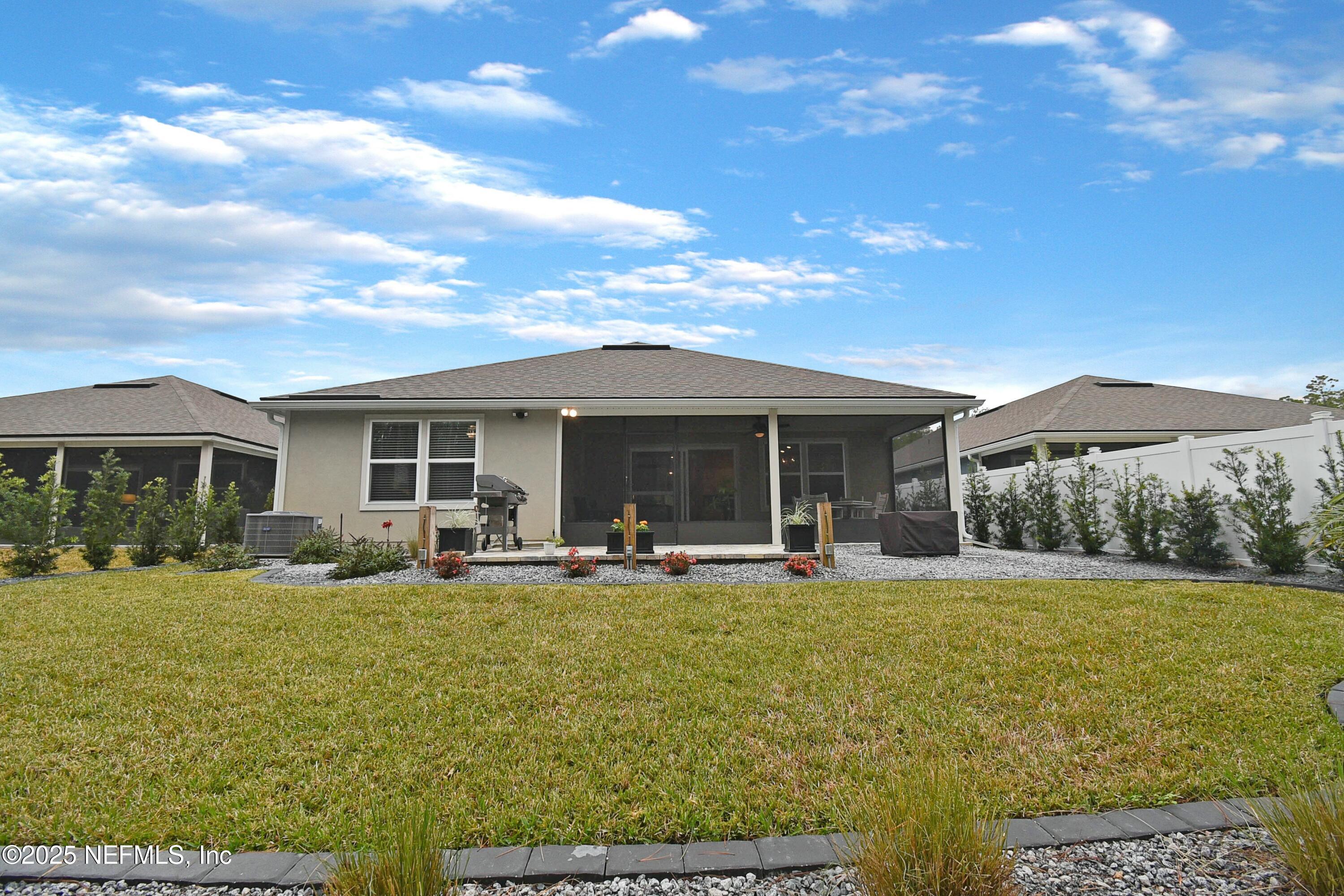 1399 Parkland Trail St. Augustine, FL 32095 - Photo 30 of 39 a front view of house with yard and outdoor seating