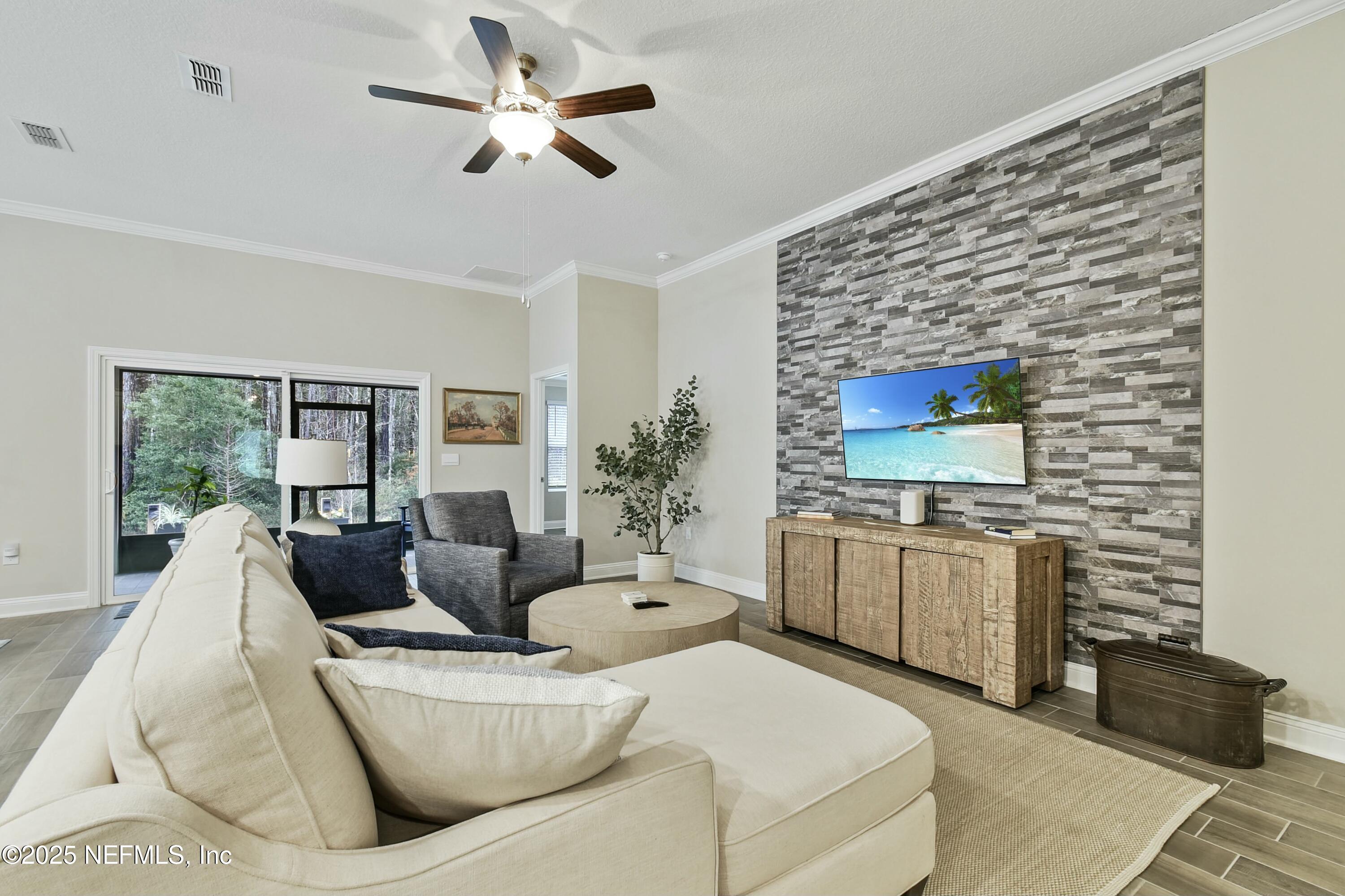 1399 Parkland Trail St. Augustine, FL 32095 - Photo 7 of 39 a living room with furniture and a flat screen tv