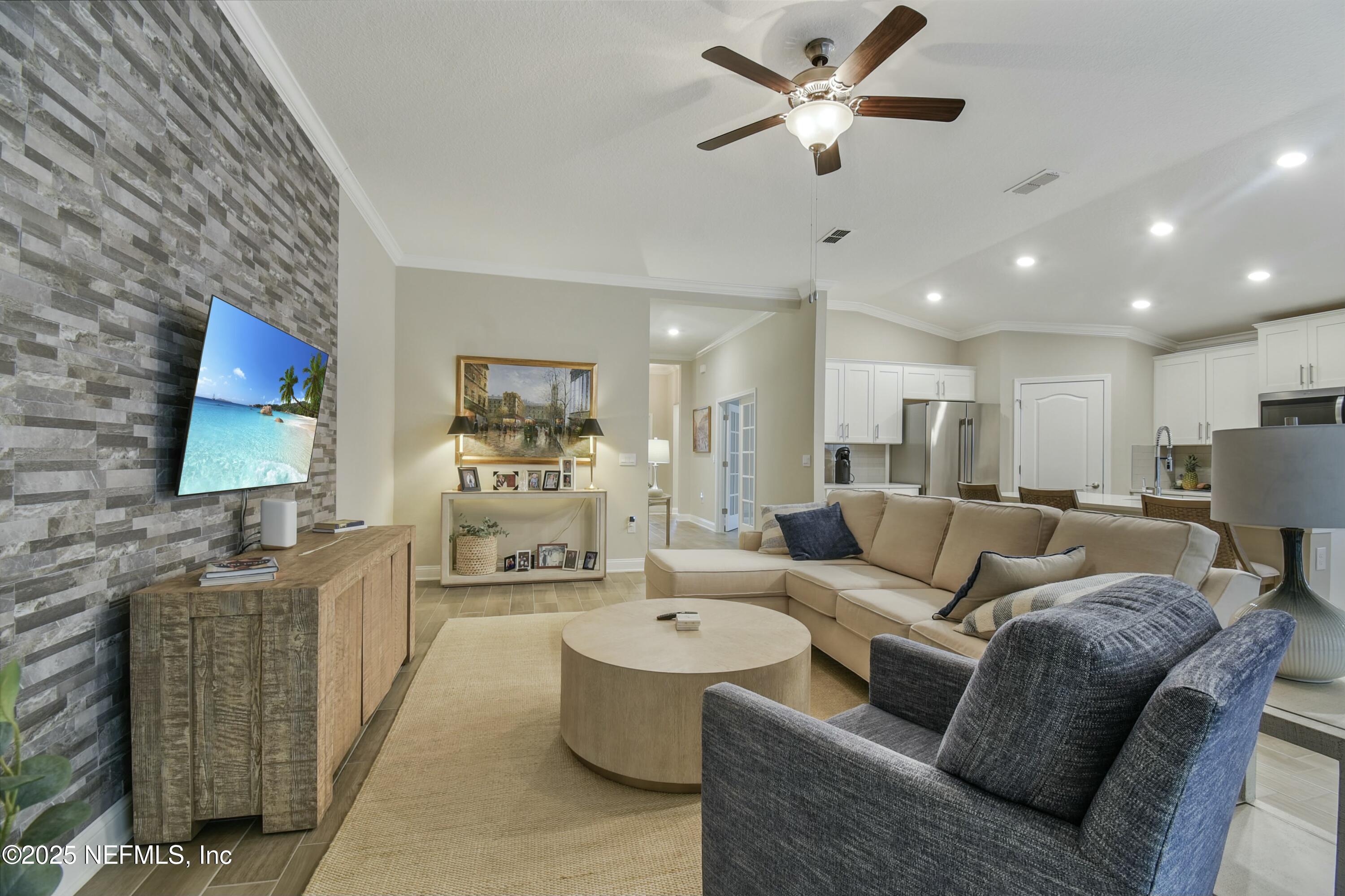 1399 Parkland Trail St. Augustine, FL 32095 - Photo 8 of 39 a living room with furniture and a flat screen tv