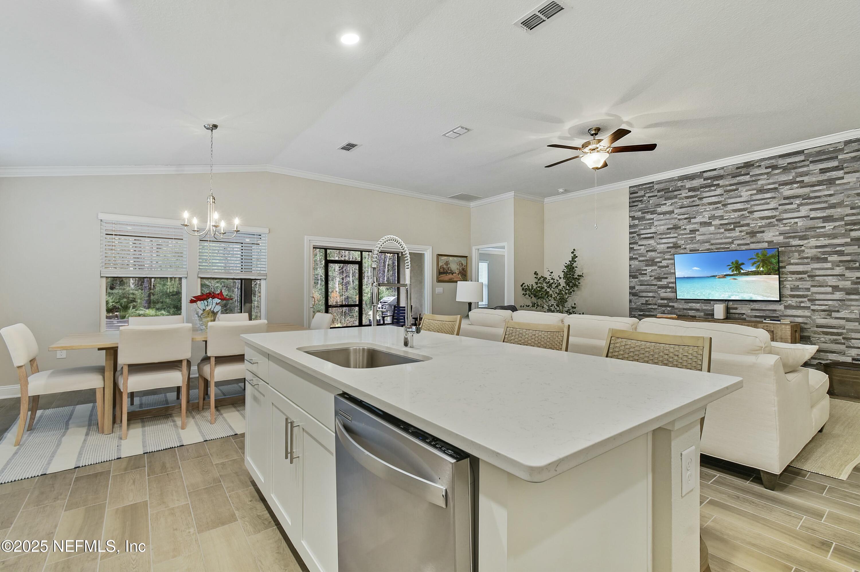1399 Parkland Trail St. Augustine, FL 32095 - Photo 10 of 39 a kitchen with stainless steel appliances granite countertop a sink and a refrigerator
