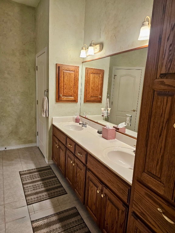 101 Texas Traditions Georgetown, TX 78628 - Photo 17 of 17 Bathroom with double vanity, light tile patterned floors, and a textured wall