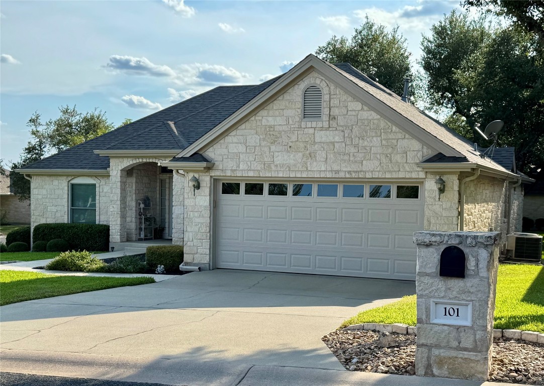 101 Texas Traditions Georgetown, TX 78628 - Photo 2 of 17 French country inspired facade featuring a garage, stone siding, concrete driveway, and roof with shingles