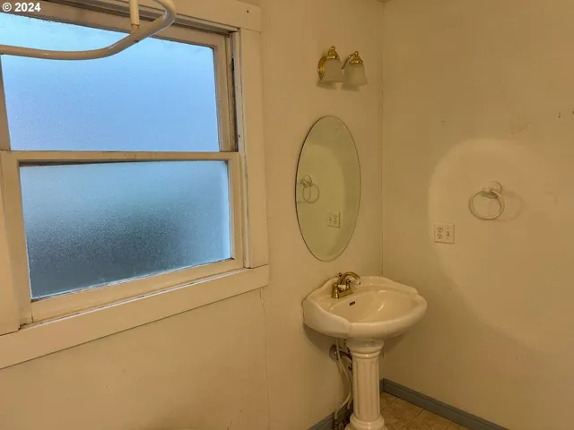 a bathroom with a sink a mirror and a shower