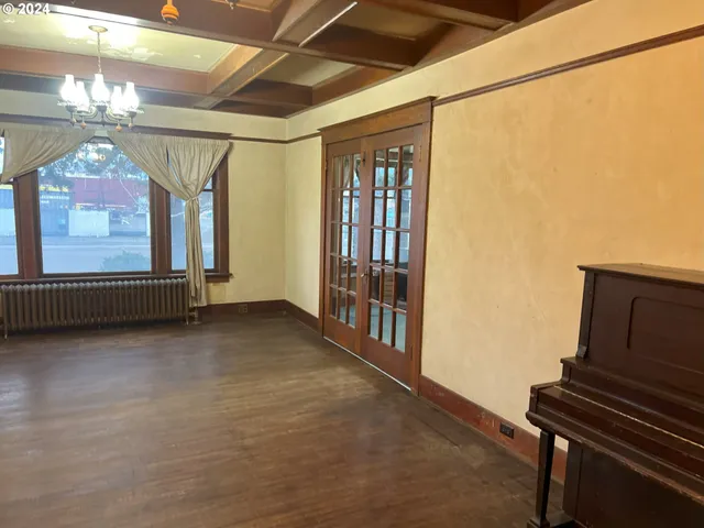 a view of an empty room with a fireplace and a window
