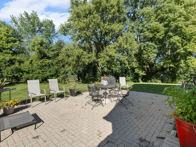 a view of a backyard with sitting area