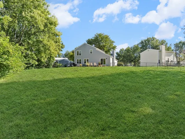 a front view of a house with a garden and yard