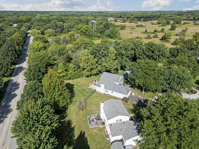 an aerial view of a house with a yard