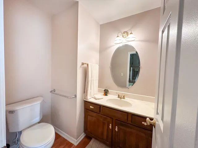 a bathroom with a toilet sink and mirror