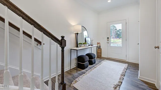 a kitchen with a table chairs stove and wooden floor