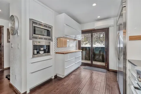 a kitchen with stainless steel appliances a refrigerator and a stove top oven
