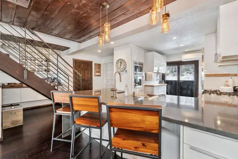 a kitchen with stainless steel appliances granite countertop sink cabinets and wooden floor