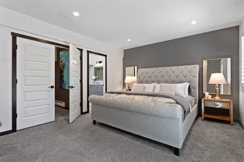 a spacious bedroom with a bed and walk in closet