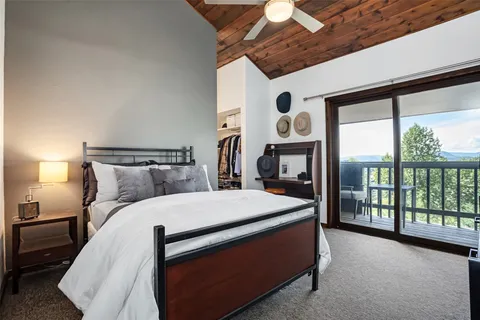 a large bed sitting in a bedroom next to a large window