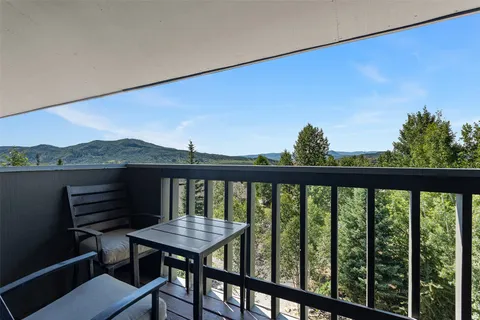 a view of a balcony with furniture and a potted plant